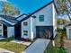 Modern two-story home featuring a black garage door and landscaped yard at 720 W 14Th St, Lakeland, FL 33805