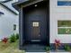 The black front door with window grids matches the trim and accent wall on the modern exterior at 720 W 14Th St, Lakeland, FL 33805