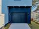 The dark garage door complements the light exterior at 720 W 14Th St, Lakeland, FL 33805