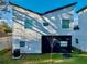 The back exterior features a dark garage door and multiple windows with a view of the yard at 720 W 14Th St, Lakeland, FL 33805