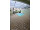 A cozy splash pool is surrounded by brick pavers and topped with a screened enclosure at 1533 Still Dr, Clermont, FL 34714