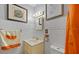 Traditional bathroom with framed art, vanity, and orange patterned shower curtain at 2453 Teri St, Auburndale, FL 33823