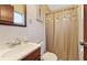 Modest bathroom with tiled walls and a shower curtain with floral accents at 2453 Teri St, Auburndale, FL 33823