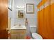 Simple bathroom with a vanity and an orange shower curtain with white embellishments at 2453 Teri St, Auburndale, FL 33823