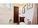 Small bathroom featuring a tiled wall and a wooden door with a dark finish at 2453 Teri St, Auburndale, FL 33823