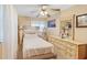 Cozy bedroom featuring a ceiling fan and a dresser with a decorative mirror at 2453 Teri St, Auburndale, FL 33823