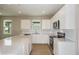 Modern kitchen features white cabinets, stainless steel appliances, quartz countertops and a large center island at 5333 Sw 81St Cir, Ocala, FL 34481