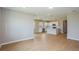 Spacious living space featuring wood-look floors and seamless flow into a modern kitchen at 5333 Sw 81St Cir, Ocala, FL 34481
