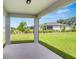 Covered patio overlooking a well-manicured lawn and landscaping at 5333 Sw 81St Cir, Ocala, FL 34481