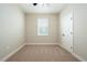 Neutral bedroom with carpet flooring, a window with blinds and a white door at 7721 Somersworth Dr, Kissimmee, FL 34747