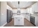 Bright kitchen with white cabinets, stainless steel appliances, and an island with white countertop at 7721 Somersworth Dr, Kissimmee, FL 34747