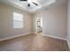 Spacious main bedroom with a tray ceiling, ceiling fan, and an en-suite bathroom at 7721 Somersworth Dr, Kissimmee, FL 34747