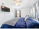 Bedroom with a ceiling fan, TV, closet, and a window with lovely curtains at 1625 Crystal E Ct, Lakeland, FL 33801