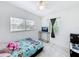 Cozy bedroom with a TV, ceiling fan, and ample natural light from two windows at 1625 Crystal E Ct, Lakeland, FL 33801
