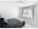 Cozy bedroom with a comfortable bed, ceiling fan, and a window for natural lighting at 1625 Crystal E Ct, Lakeland, FL 33801