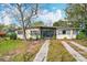 Charming single-story home with a well-maintained lawn and mature landscaping at 1625 Crystal E Ct, Lakeland, FL 33801