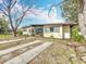 Charming single-story home with a well-maintained lawn and mature landscaping at 1625 Crystal E Ct, Lakeland, FL 33801