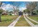 Charming single-story home with a well-maintained lawn and mature trees at 1625 Crystal E Ct, Lakeland, FL 33801