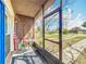 Inviting screened front porch with seating area and view of the front yard at 1625 Crystal E Ct, Lakeland, FL 33801