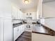 Well-lit kitchen featuring white cabinets, dark countertops, and modern appliances at 1625 Crystal E Ct, Lakeland, FL 33801