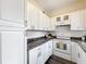 Bright kitchen equipped with white cabinetry, stainless steel appliances, and a subway tile backsplash at 1625 Crystal E Ct, Lakeland, FL 33801