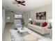 Cozy living room area furnished with a sofa, chairs, rug and a ceiling fan at 1625 Crystal E Ct, Lakeland, FL 33801