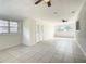 Bright and airy living room featuring tile floors, ceiling fans and plenty of natural light at 1625 Crystal E Ct, Lakeland, FL 33801