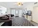 Inviting living room featuring a plush couch, stylish rug, and a ceiling fan for added comfort at 1625 Crystal E Ct, Lakeland, FL 33801