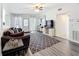 Bright living room featuring modern flooring, ceiling fan and large windows at 1625 Crystal E Ct, Lakeland, FL 33801