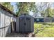 Backyard storage shed with double doors and a window at 1016 W 12Th St, Lakeland, FL 33805