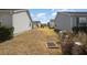 View of the side yard area showcasing the community design and low-maintenance landscaping at 1654 Indigo Ave, The Villages, FL 32162