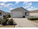 Single-story home with a well-manicured lawn and white picket fence offers great curb appeal at 1654 Indigo Ave, The Villages, FL 32162