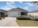 Charming single-story home with a well-manicured lawn and white picket fence offers curb appeal at 1654 Indigo Ave, The Villages, FL 32162