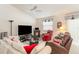 Cozy living room with comfortable seating, a fireplace, and a ceiling fan, perfect for relaxation at 1654 Indigo Ave, The Villages, FL 32162