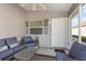 Covered porch with comfortable seating, perfect for relaxing at 1654 Indigo Ave, The Villages, FL 32162