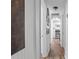 Hallway with wood floors leading to the kitchen and other rooms at 828 W 13Th St, Lakeland, FL 33805