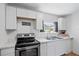Bright kitchen featuring white cabinets, stainless steel appliances, and a window at 828 W 13Th St, Lakeland, FL 33805