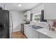 Modern kitchen with stainless steel appliances, white cabinetry, and window view at 828 W 13Th St, Lakeland, FL 33805