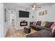 Comfortable living room features a fireplace, ceiling fan, and wood-look laminate flooring at 828 W 13Th St, Lakeland, FL 33805