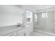 Modern bathroom with a glass-enclosed shower, white cabinets and sleek fixtures at 5224 Stone Ridge Pl, St Cloud, FL 34771