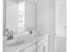 Bright bathroom featuring double sinks, white cabinetry and a large mirror at 5224 Stone Ridge Pl, St Cloud, FL 34771