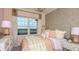 Charming pink-themed bedroom with a cozy bed and patterned wallpaper at 5224 Stone Ridge Pl, St Cloud, FL 34771