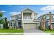 Two-story home with a two-car garage, well-maintained lawn, and a charming covered front porch at 5224 Stone Ridge Pl, St Cloud, FL 34771