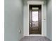 A modern front door with glass paneling and sleek hardware enhancing the entryway's curb appeal at 5224 Stone Ridge Pl, St Cloud, FL 34771