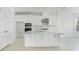 Bright kitchen features white cabinets, stainless steel appliances, quartz countertops, and a central island at 5224 Stone Ridge Pl, St Cloud, FL 34771