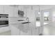 Modern kitchen features an island, stainless steel appliances, pendant lighting, and ample natural light at 5224 Stone Ridge Pl, St Cloud, FL 34771