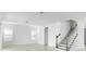 Bright living room area features tile flooring, staircase with wood trim and two windows at 5224 Stone Ridge Pl, St Cloud, FL 34771