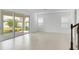 Open living space with light tile flooring, large sliding glass doors, and modern staircase at 5224 Stone Ridge Pl, St Cloud, FL 34771