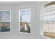 Bright room featuring three large windows with neighborhood views and white blinds at 5224 Stone Ridge Pl, St Cloud, FL 34771