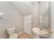 Bathroom featuring a pedestal sink, beige tile floor, and a standard toilet at 5331 River Rock Rd, Lakeland, FL 33809